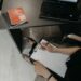 Person preparing business documents at a desk with a laptop