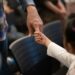 Adult holding a child's hand to illustrate family unity